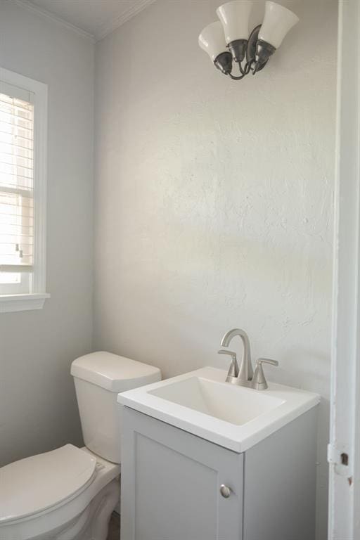 1627 Sheffield Rd, Oklahoma City, OK 73120 - half bath featuring vanity, ornamental molding, and a chandelier