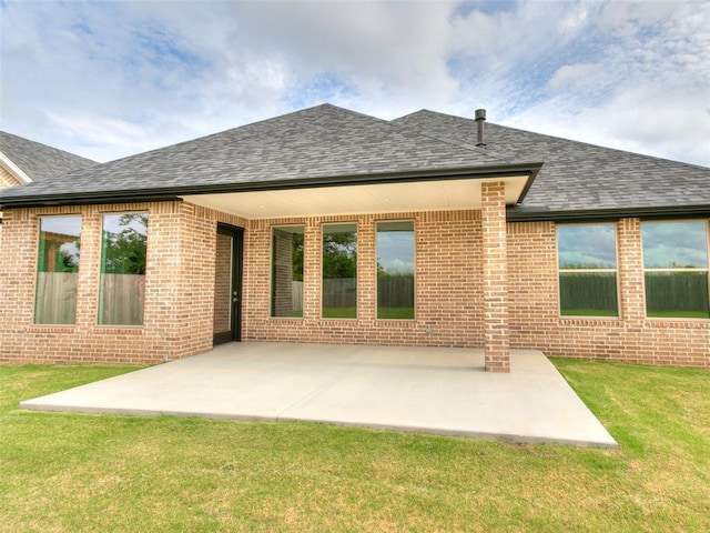208 Pont Neuf Ct, Edmond, OK 73034 - rear view of property featuring roof with shingles, brick siding, and a yard