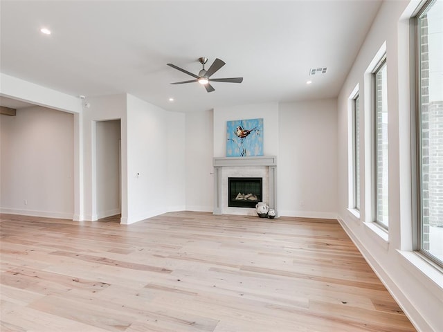 208 Pont Neuf Ct, Edmond, OK 73034 - unfurnished living room with a ceiling fan, light wood-type flooring, a glass covered fireplace, and recessed lighting