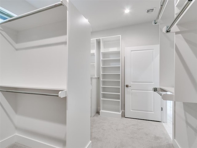 208 Pont Neuf Ct, Edmond, OK 73034 - walk in closet with carpet flooring