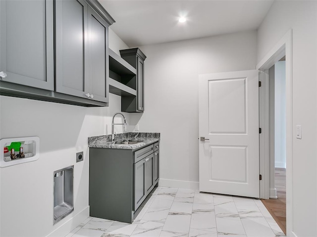 208 Pont Neuf Ct, Edmond, OK 73034 - laundry room featuring washer hookup, hookup for an electric dryer, cabinet space, and light marble finish floors