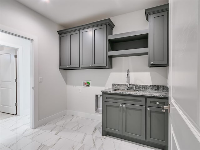 208 Pont Neuf Ct, Edmond, OK 73034 - washroom with washer hookup, light marble finish floors, and cabinet space