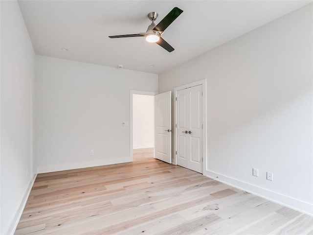 208 Pont Neuf Ct, Edmond, OK 73034 - unfurnished bedroom featuring light wood finished floors, ceiling fan, and a closet