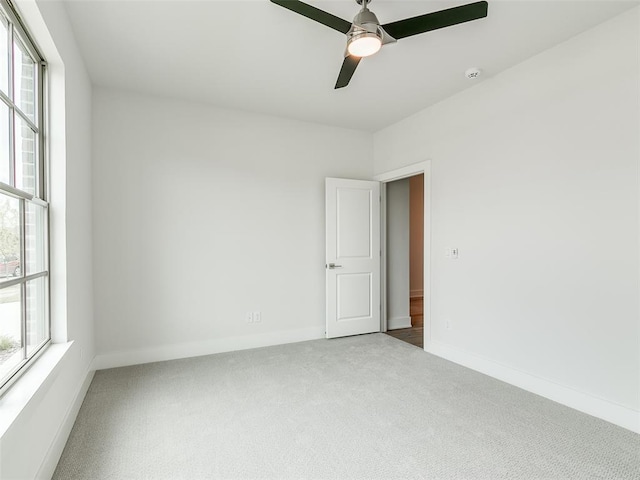 208 Pont Neuf Ct, Edmond, OK 73034 - empty room with carpet floors, healthy amount of natural light, ceiling fan, and a smoke detector
