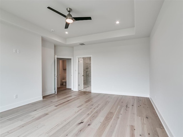 208 Pont Neuf Ct, Edmond, OK 73034 - empty room featuring light wood finished floors, a tray ceiling, ceiling fan, and recessed lighting