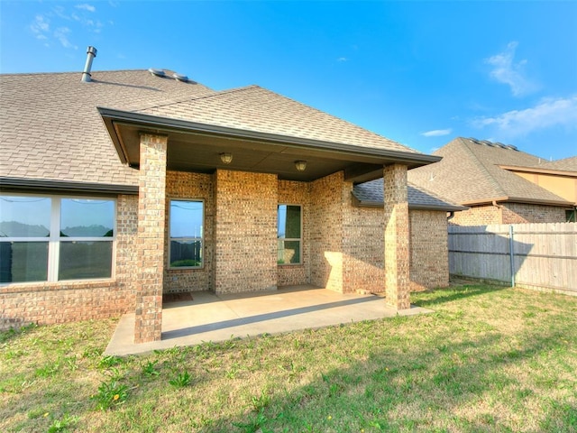3205 NW 192nd Ter, Edmond, OK 73012 - back of house with brick siding, roof with shingles, and a patio