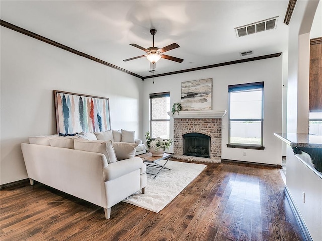 3205 NW 192nd Ter, Edmond, OK 73012 - living area with a ceiling fan, dark wood finished floors, ornamental molding, and a fireplace