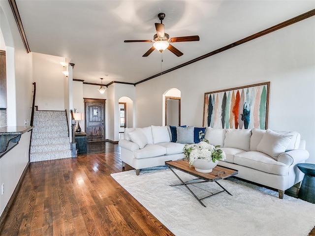 3205 NW 192nd Ter, Edmond, OK 73012 - living room featuring arched walkways, a ceiling fan, dark wood-style floors, ornamental molding, and stairway