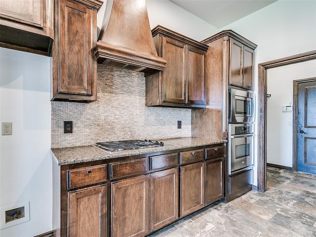 3205 NW 192nd Ter, Edmond, OK 73012 - kitchen featuring premium range hood, appliances with stainless steel finishes, stone counters, and decorative backsplash