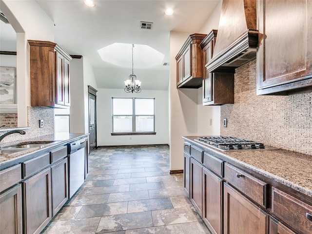3205 NW 192nd Ter, Edmond, OK 73012 - kitchen with stainless steel appliances, custom range hood, decorative backsplash, a chandelier, and arched walkways