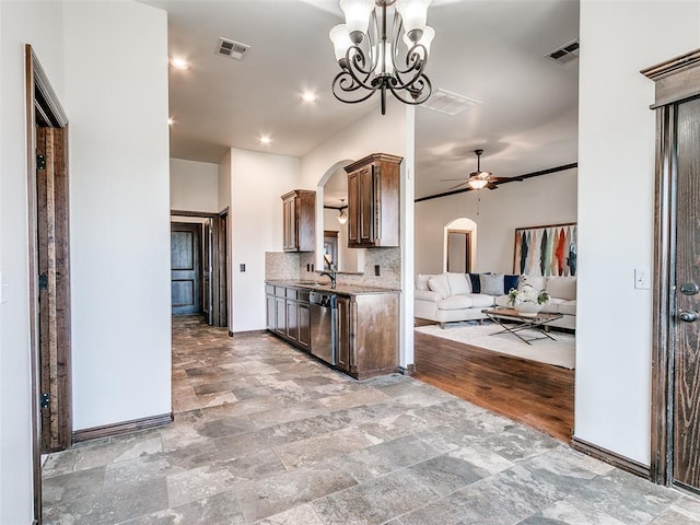 3205 NW 192nd Ter, Edmond, OK 73012 - kitchen featuring dishwasher, decorative backsplash, arched walkways, ceiling fan, and light stone finish floors