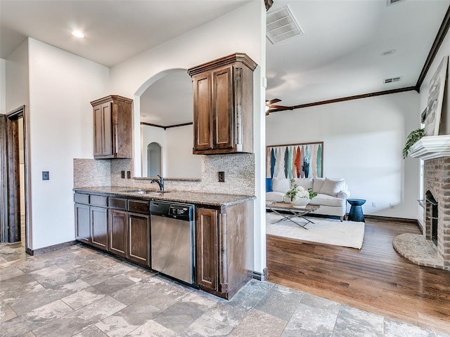 3205 NW 192nd Ter, Edmond, OK 73012 - kitchen featuring dishwasher, arched walkways, backsplash, stone counters, and ceiling fan