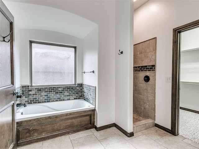 3205 NW 192nd Ter, Edmond, OK 73012 - bathroom featuring a bath, a tile shower, and tile patterned flooring