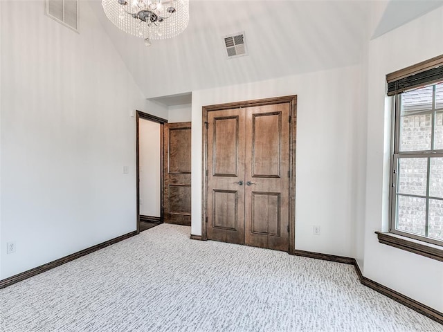 3205 NW 192nd Ter, Edmond, OK 73012 - unfurnished bedroom with a chandelier, carpet floors, and lofted ceiling