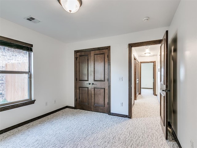3205 NW 192nd Ter, Edmond, OK 73012 - unfurnished bedroom featuring light carpet and a closet