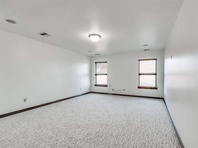3205 NW 192nd Ter, Edmond, OK 73012 - spare room featuring light colored carpet and plenty of natural light