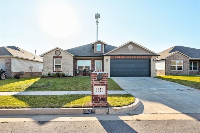 1621 Tumbleweed Way, El Reno, OK 73036 - view of front facade featuring driveway, a front lawn, a garage, stone siding, and brick siding
