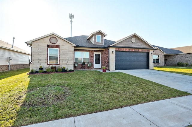1621 Tumbleweed Way, El Reno, OK 73036 - view of front of property featuring an attached garage, driveway, a front lawn, and stone siding
