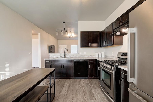 1621 Tumbleweed Way, El Reno, OK 73036 - kitchen with freestanding refrigerator, black dishwasher, gas range, under cabinet range hood, and light wood-type flooring