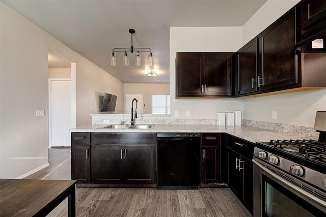 1621 Tumbleweed Way, El Reno, OK 73036 - kitchen featuring black dishwasher, stainless steel gas range, light wood finished floors, a peninsula, and pendant lighting