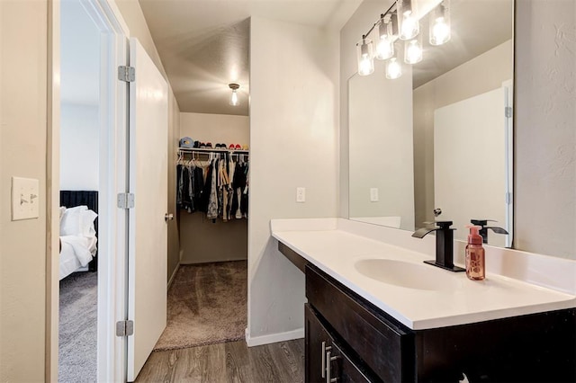 1621 Tumbleweed Way, El Reno, OK 73036 - ensuite bathroom with vanity, wood finished floors, and a spacious closet