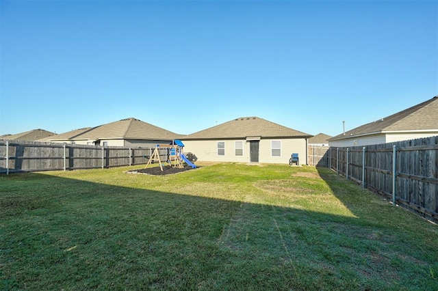 1621 Tumbleweed Way, El Reno, OK 73036 - rear view of property featuring a playground and a fenced backyard