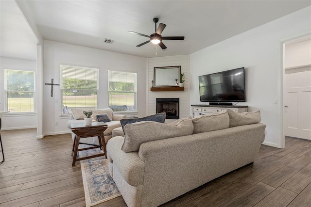 2666 Legacy Pl, Shawnee, OK 74804 - living area featuring a ceiling fan, wood finished floors, a large fireplace, and plenty of natural light