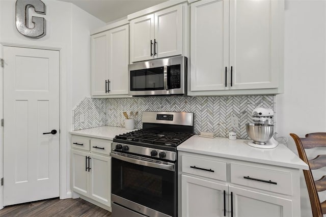 2666 Legacy Pl, Shawnee, OK 74804 - kitchen featuring stainless steel appliances, tasteful backsplash, light countertops, dark wood-style flooring, and white cabinets