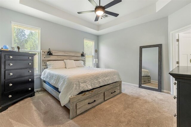 2666 Legacy Pl, Shawnee, OK 74804 - bedroom with light carpet, a tray ceiling, and ceiling fan