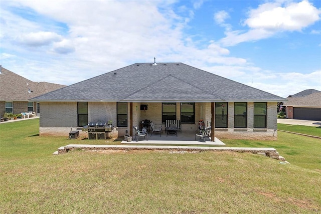 2666 Legacy Pl, Shawnee, OK 74804 - back of house featuring brick siding, a shingled roof, a lawn, and a patio area