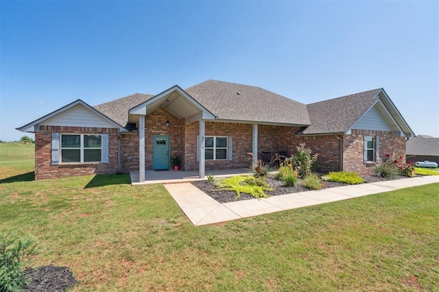 2316 Dixie Dr, Blanchard, OK 73010 - ranch-style home featuring a shingled roof, brick siding, and a front lawn