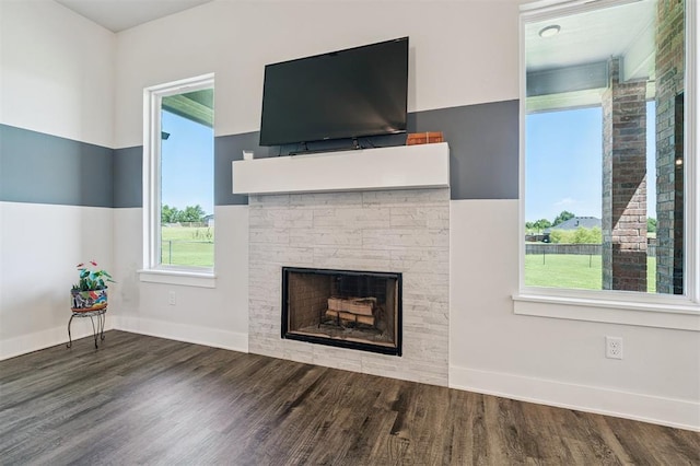 2316 Dixie Dr, Blanchard, OK 73010 - unfurnished living room featuring wood finished floors and a stone fireplace