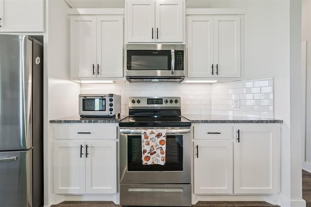 2316 Dixie Dr, Blanchard, OK 73010 - kitchen with appliances with stainless steel finishes, white cabinets, dark stone counters, and tasteful backsplash