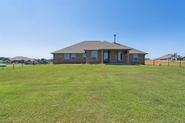 2316 Dixie Dr, Blanchard, OK 73010 - view of front of home with a front yard and roof with shingles