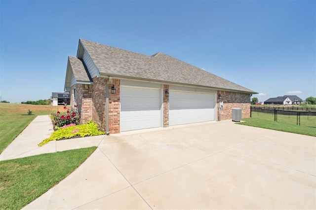 2316 Dixie Dr, Blanchard, OK 73010 - view of side of property with brick siding, driveway, roof with shingles, and an attached garage