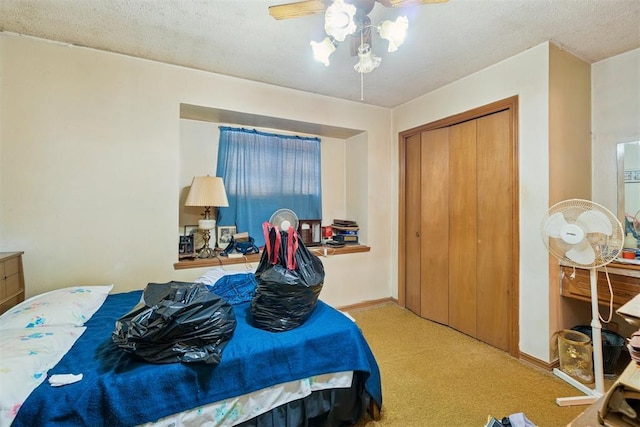 720 NW 16th St, Moore, OK 73160 - carpeted bedroom featuring a closet, ceiling fan, and a textured ceiling