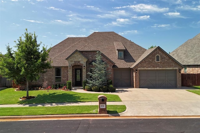 8512 NW 126th St, Oklahoma City, OK 73142 - french country home featuring brick siding, concrete driveway, a garage, and roof with shingles