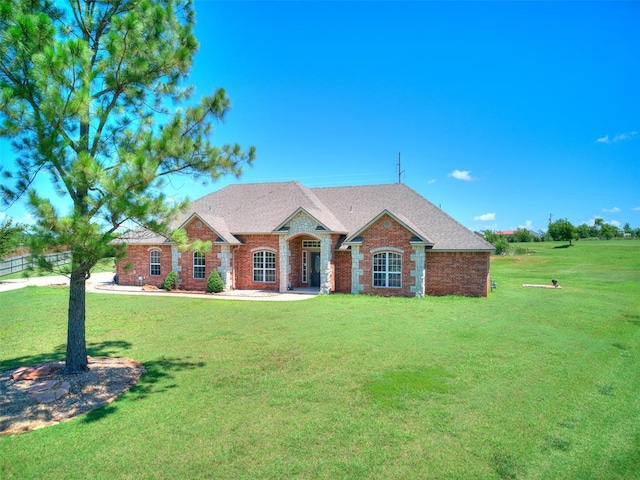 4813 SE 28th St, Oklahoma City, OK 73165 - view of front facade with a front lawn, brick siding, and a shingled roof