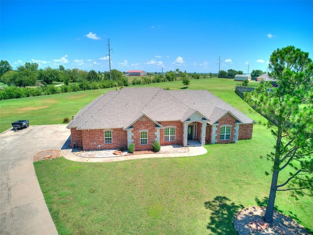 4813 SE 28th St, Oklahoma City, OK 73165 - view of front of house with brick siding, a front yard, driveway, and a shingled roof