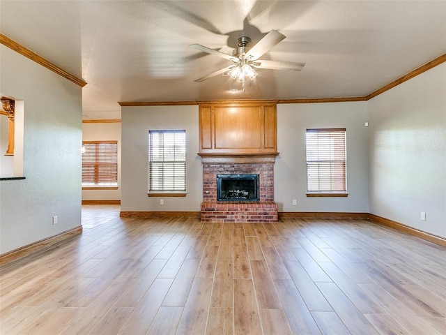 4813 SE 28th St, Oklahoma City, OK 73165 - unfurnished living room with crown molding, plenty of natural light, a ceiling fan, light wood-style floors, and a brick fireplace