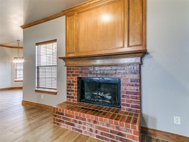 4813 SE 28th St, Oklahoma City, OK 73165 - detailed view of ornamental molding, a fireplace, wood finished floors, and a chandelier