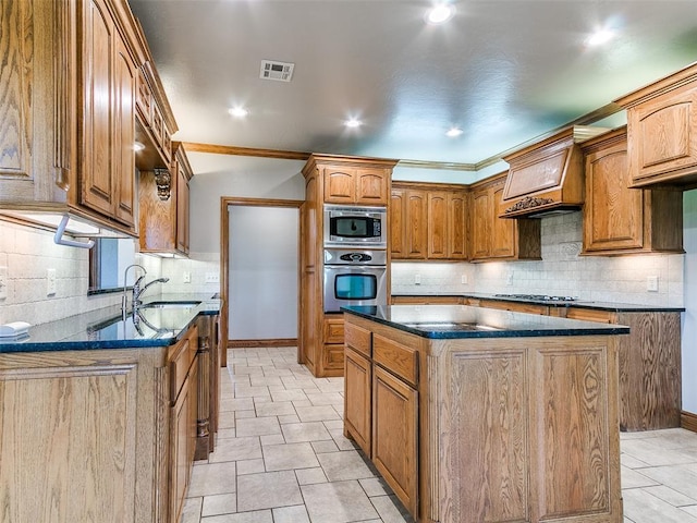 4813 SE 28th St, Oklahoma City, OK 73165 - kitchen with stainless steel appliances, tasteful backsplash, custom exhaust hood, brown cabinetry, and a kitchen island