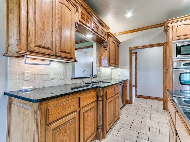 4813 SE 28th St, Oklahoma City, OK 73165 - kitchen with stainless steel appliances, tasteful backsplash, brown cabinets, dark stone countertops, and ornamental molding