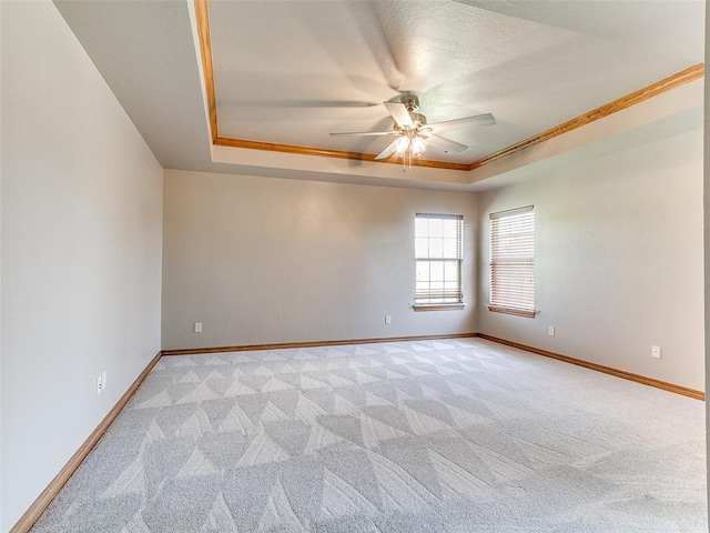4813 SE 28th St, Oklahoma City, OK 73165 - spare room featuring a tray ceiling, ceiling fan, light carpet, and crown molding