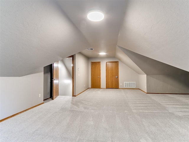 4813 SE 28th St, Oklahoma City, OK 73165 - bonus room with lofted ceiling, carpet floors, and a textured ceiling