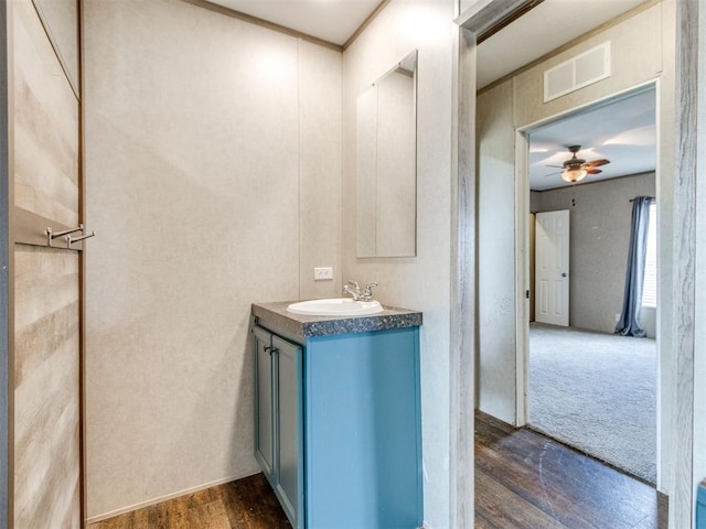 27795 N 2880th Rd, Kingfisher, OK 73750 - bathroom with vanity, wood finished floors, and ceiling fan