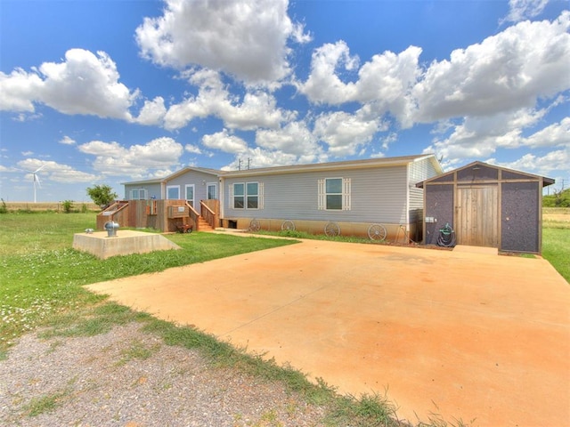27795 N 2880th Rd, Kingfisher, OK 73750 - back of property featuring a storage shed, a deck, and a yard
