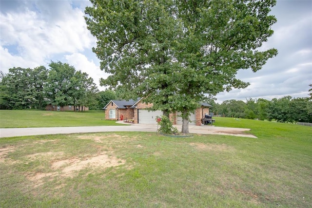 7712 Timber Creek Dr, Choctaw, OK 73020 - view of grassy yard featuring a garage and driveway