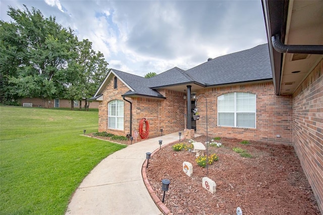 7712 Timber Creek Dr, Choctaw, OK 73020 - view of front facade with roof with shingles, brick siding, and a front lawn
