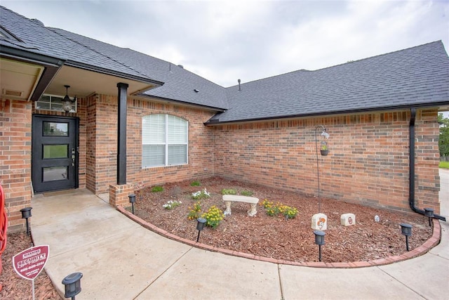 7712 Timber Creek Dr, Choctaw, OK 73020 - entrance to property with a shingled roof and brick siding